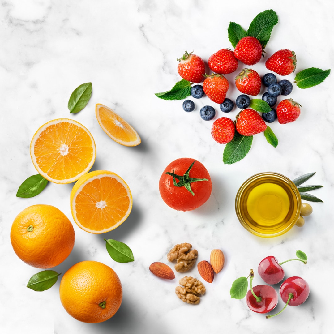 marble background with text stating foods that fight inflammation and food photographs of oranges, strawberries, blueberries, cherries, tomatoes, walnuts, almonds, olive oil