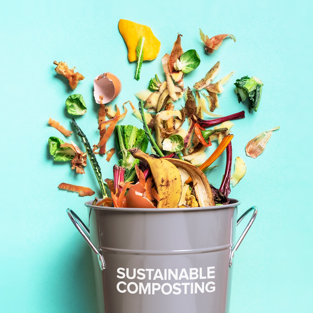 A metal bucket tipped over and fresh food scraps are spilling out